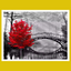 Red tree by a bridge over water 