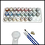 Set of paints in a plastic holder with brushes and a magnifying glass on a white background