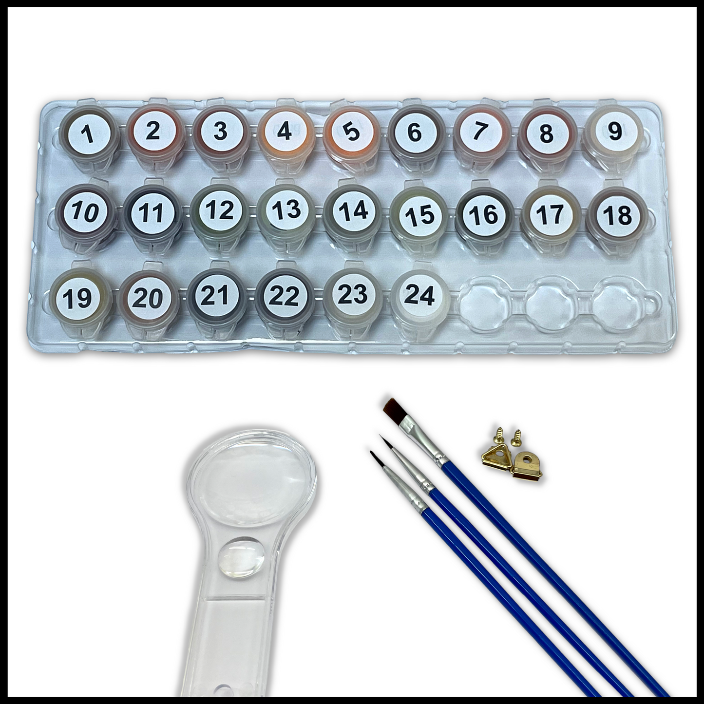 Set of paints, brushes and a magnifying glass