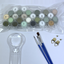 Set of paint pots, brushes, and a magnifying glass on a white background