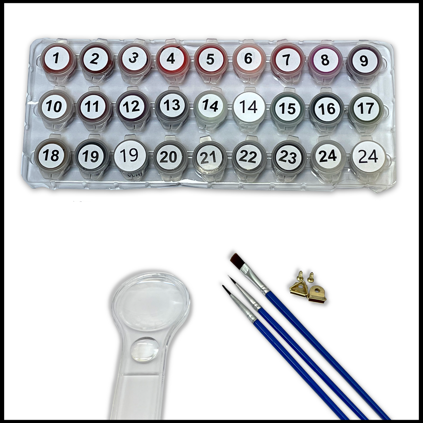 Set of paints, brushes and a magnifying glass