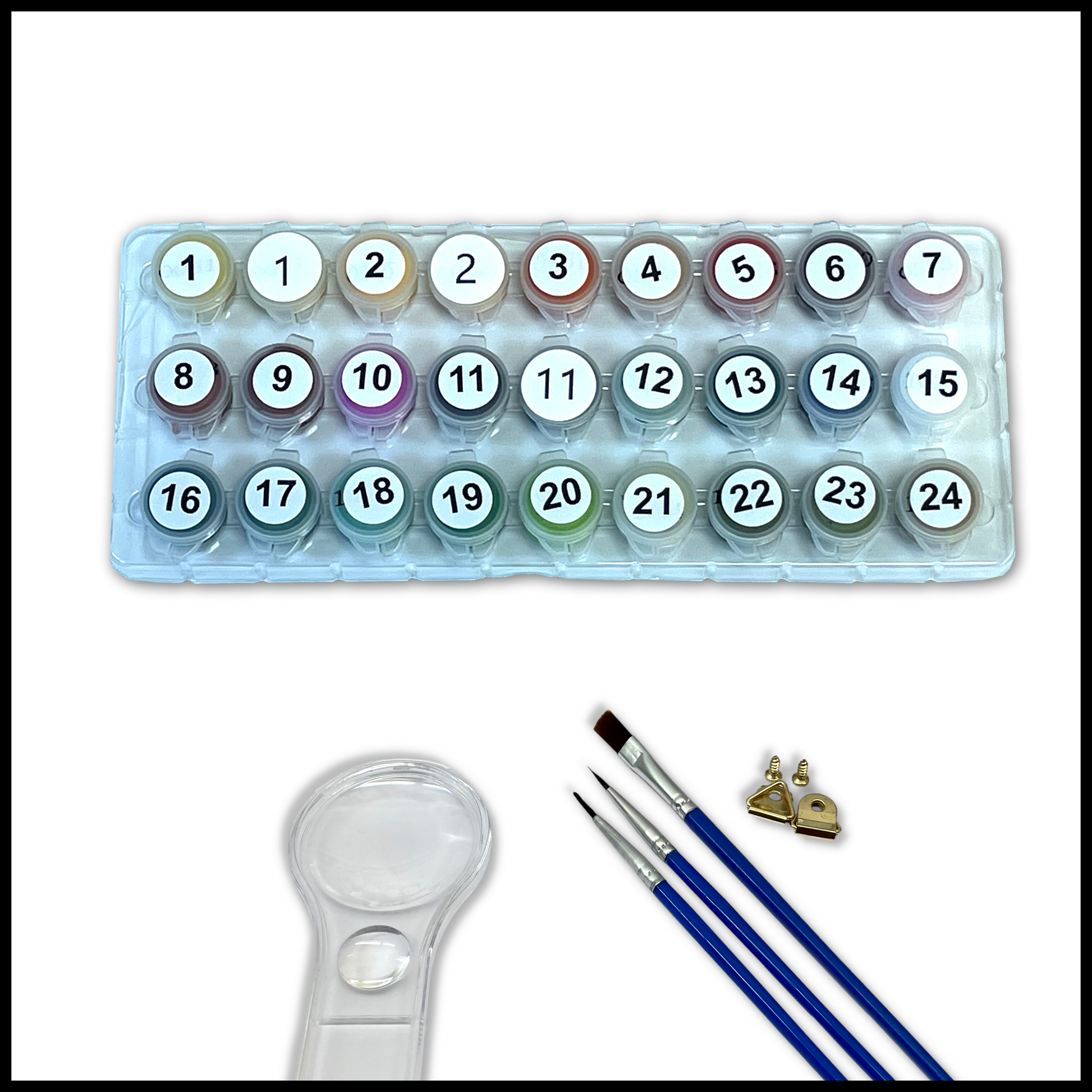 Set of paints, brushes, and a magnifying glass on a white background