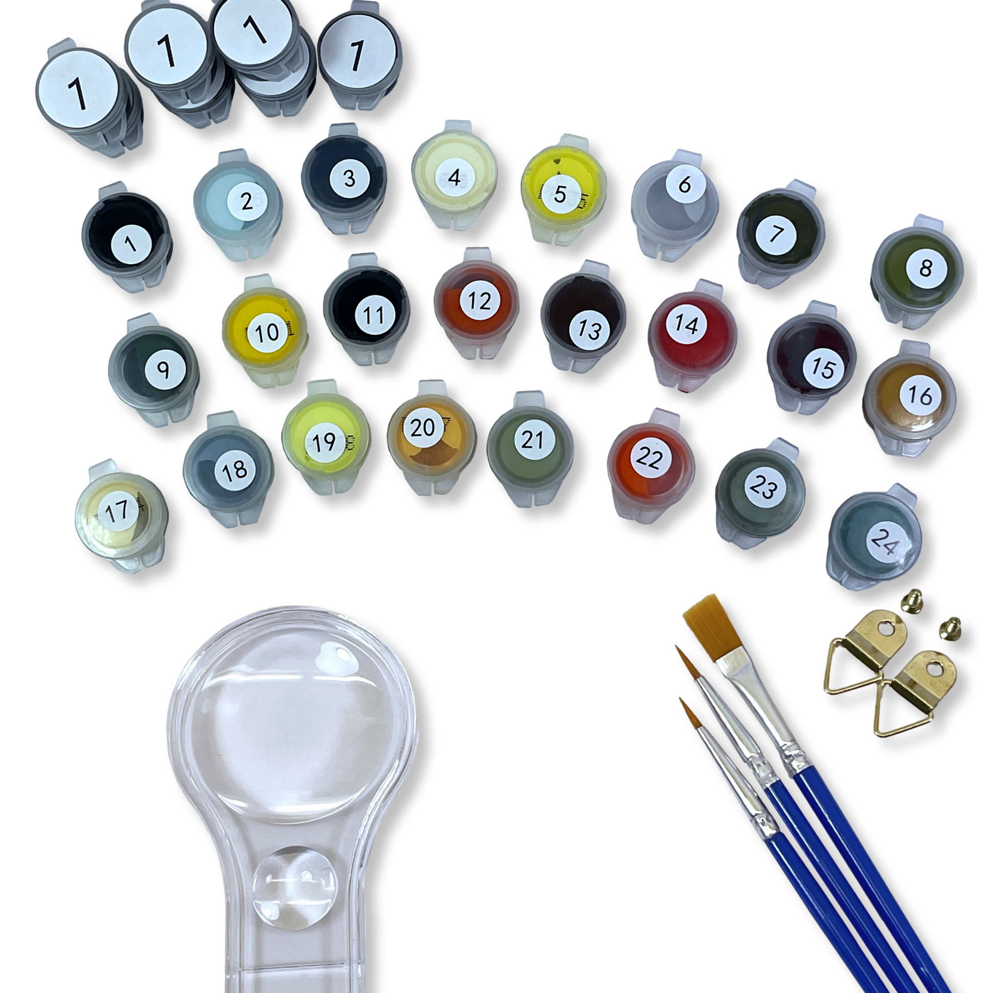 Set of paints, paint brushes, and a magnifying glass on a white background